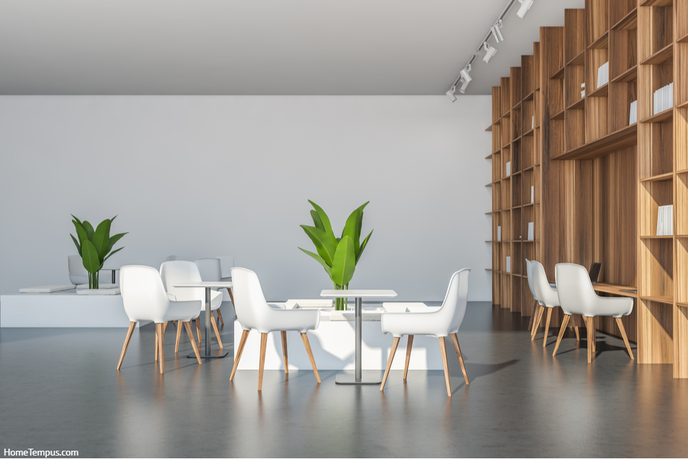 Bright white chairs with tables and seatings with indoor plants, pairing with a floor-to-ceiling wooden shelving. Grey concrete floor. Grey Walls and Vinyl Floors - What Color Floor with Grey Walls