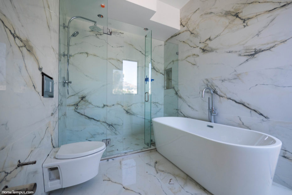 Modern bathroom interior with bathtub and glass shower enclosure
