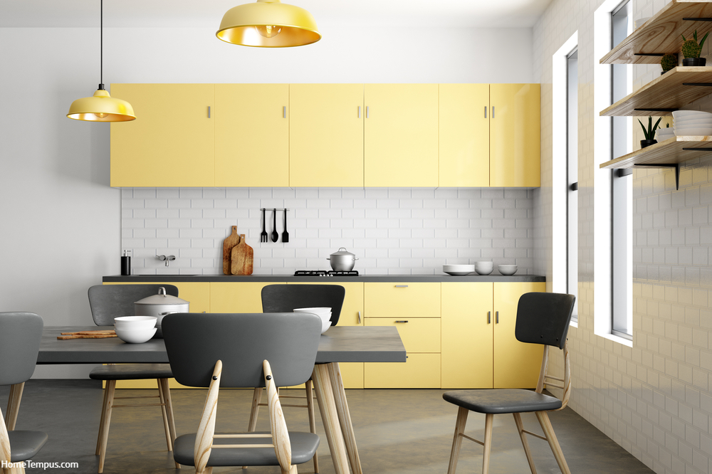 Stylish yellow kitchen interior with furniture and appliances.