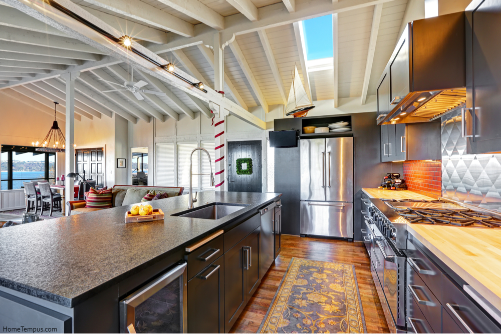 Luxury beautiful dark modern kitchen with vaulted wood ceiling, hardwood floor and huge stove. Copper colour wood floor