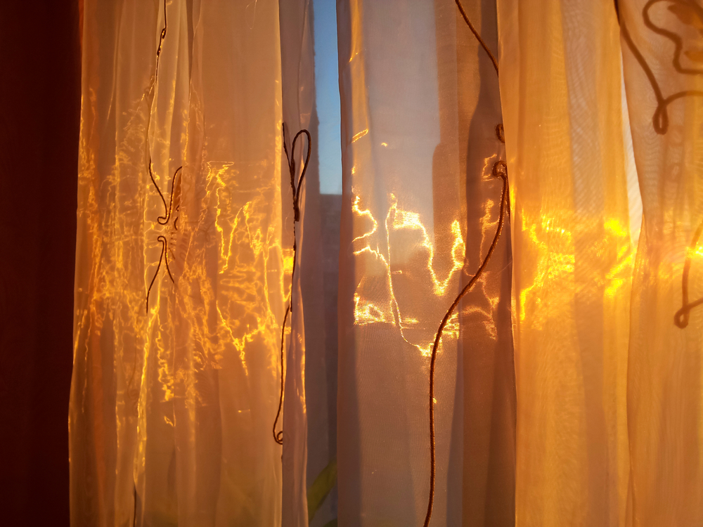 Brown organza curtains | The sun shines through an organza curtain