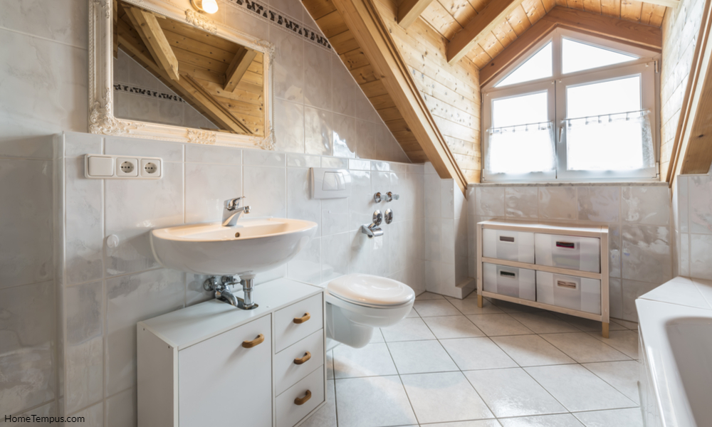 Accented Bathroom Ceilings - bathroom of a flat in attic with basin, mirror, light, window, toilet, bathtub, cabinets and wooden ceiling